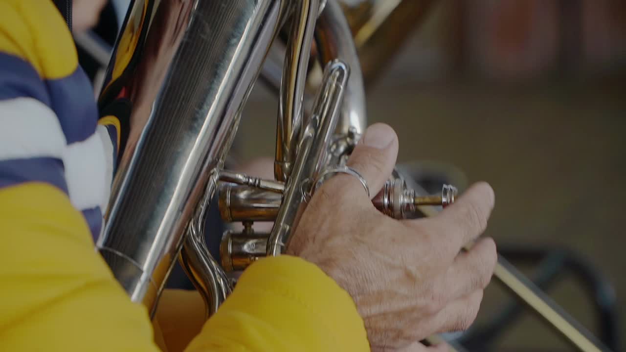 Nahaufnahme der Hand eines Euphoniumspielers beim Drücken der Ventile.