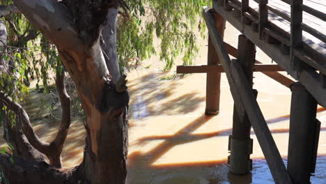 bourke historic wharf on an over flowing darling river, nsw australia