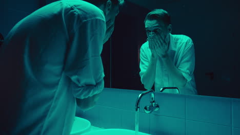 a man in a bathroom reflecting on himself