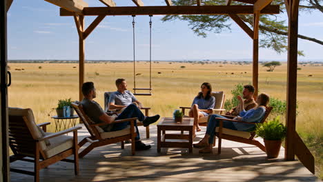 people relaxing on a porch overlooking the savanna