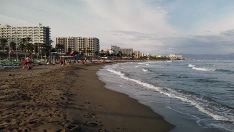 coastal beach with resort buildings and people