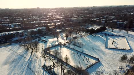 drone flying around two outdoor hockey rinks at dusk in montreal, quebec, canada