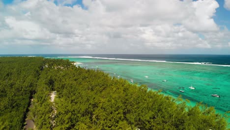 le morne beach with still boats in the crystal clear turquoise water of the indian ocean