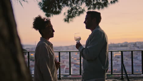 positive pair talking at evening city view closeup. multiracial people meeting