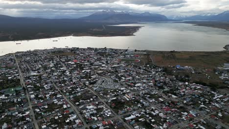 aerial view above puerto natales chile, cityscape of patagonian antarctic region, gulf montt water coast landscape and andean cordillera