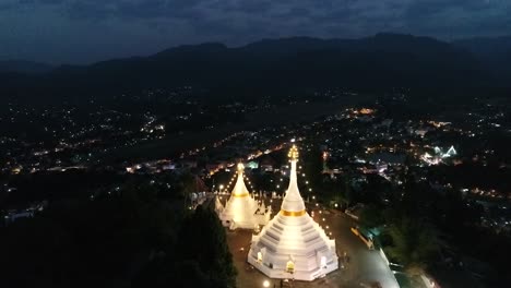 aerial footage night time of phra that doi kong moo, buddhism temple which is the landmark of mae hong son, the northern of thailand