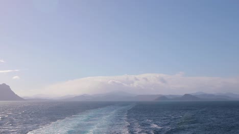 underway, traveling on the ocean, leaving behind a trail in it's wake as seen from the stern of the boat