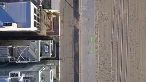 COVID-19-Lockdown-empty-beach-footprints-traces-in-sand