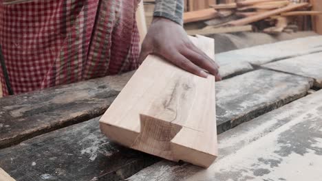 woodworking process: sanding and shaping wooden beams
