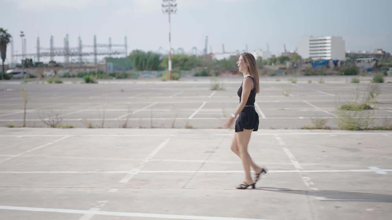 Woman Walking in Urban Parking Lot
