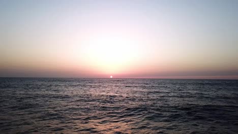 sunlight horizon over incoming ocean water tide