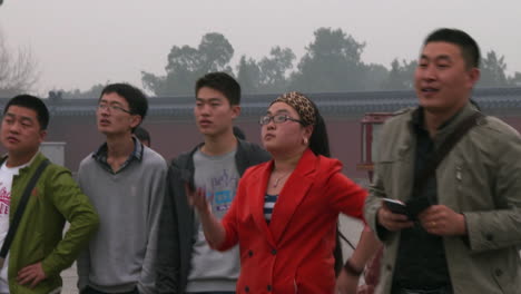 chinese tourists visit the forbidden city in beijing and take pictures on modern cellphones