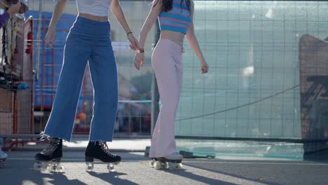 teenage girls roller skating outdoors