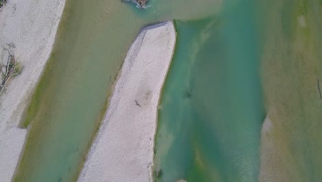 Drone-flyover-river-green-and-blue-river