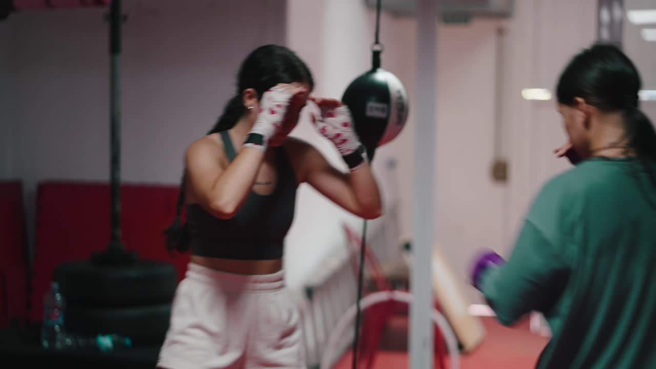 Duas adolescentes praticando boxe em uma academia