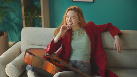 woman posing with guitar on camera