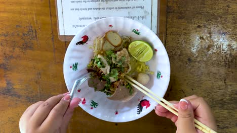 chopsticks and spoon used to eat noodles