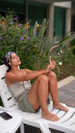 woman relaxing outdoors listening to music