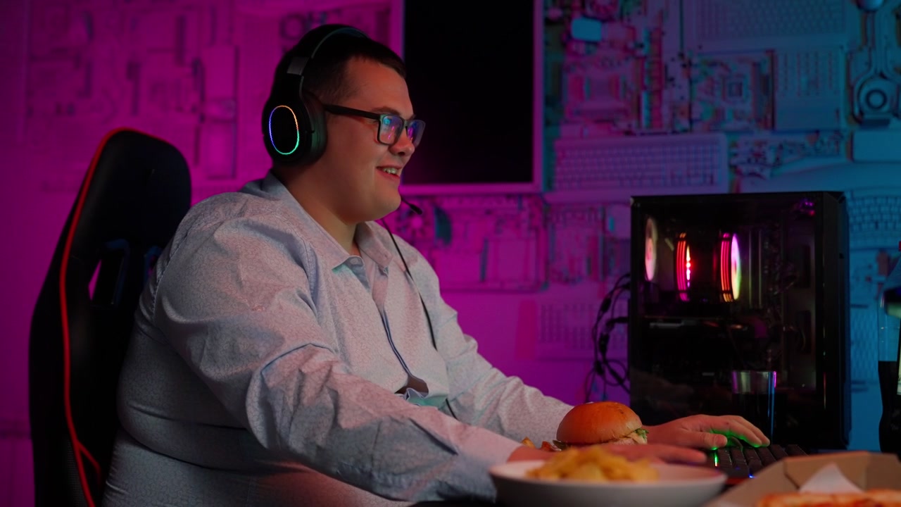Joyful Gamer Wearing Headphones Playing Online Computer Games