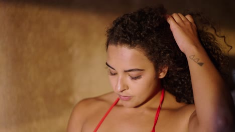 close-up portrait of a thoughtful young woman with curly hair