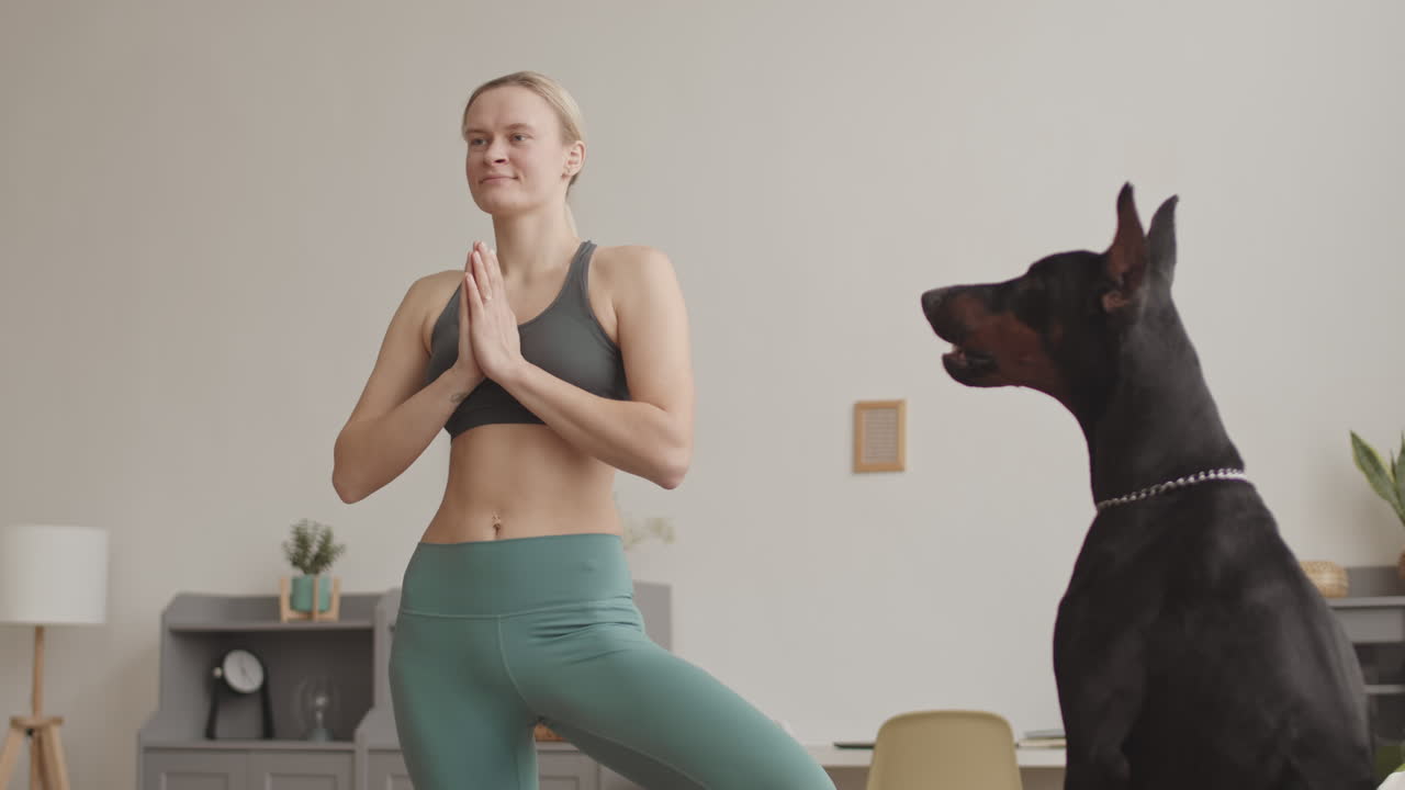 Cane che abbaia a una donna che fa yoga