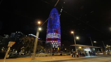 night timelapse of barcelona with illuminated torre agbar, spain