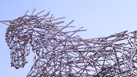 Pan-along-the-head-and-back-of-the-giant-stainless-steel-horse,-West-World,-Scottdale,-Arizona