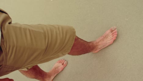 low section of man walking barefoot on the beach 4k