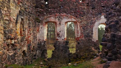 inside view of castle ruins in latvia, rauna, aerial fly backward view