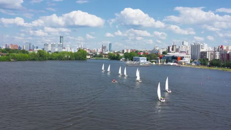 sailboats on a river in a city