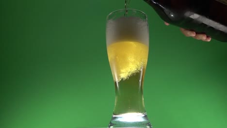 beer slowly poured on a glass