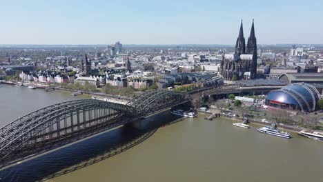 cologne cathedral, musical dome and railway bridge in a riverscape aerial of cologne city, germany