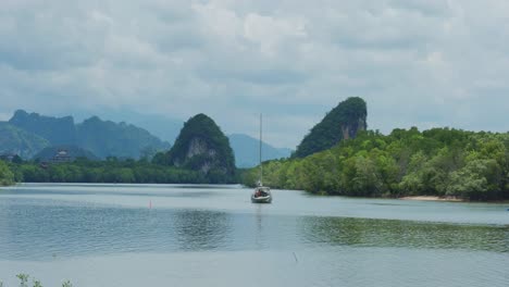 4K-Cinematic-landscape-footage-of-the-urban-forest-and-rock-formation-of-Pak-Nam-in-the-town-of-Krabi,-South-Thailand-by-the-river-marina-on-a-sunny-day