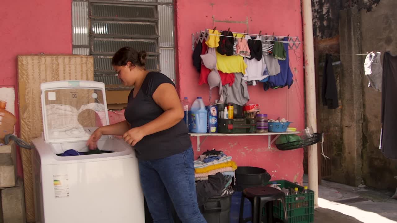 Woman Doing Laundry in a Simple Home
