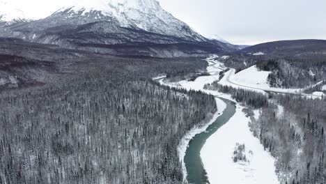 drone flies over frozen alaska river