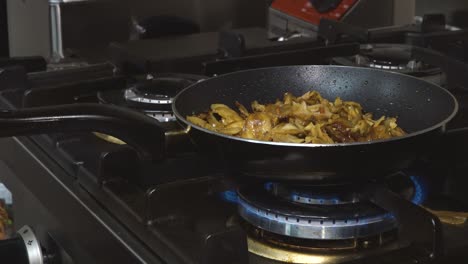 onions baked in a pan on a gas stove