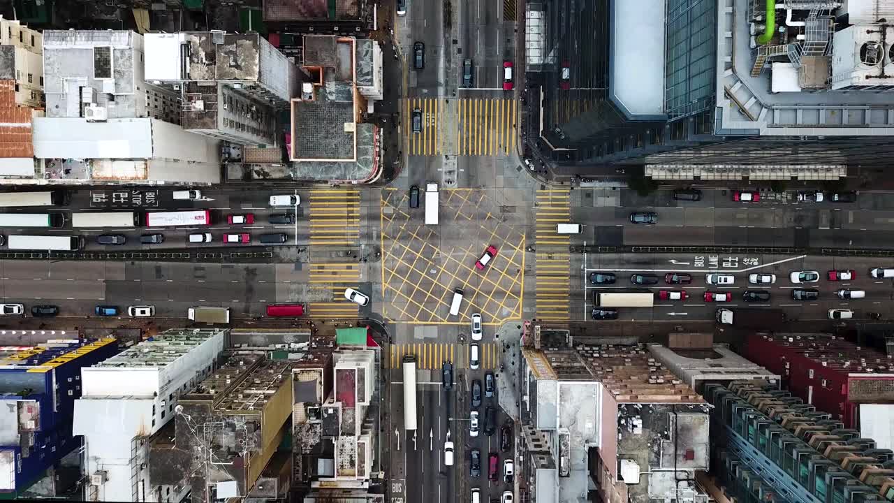 Ascendant aerial view of a road along four zebra crossing in Kowloon, Hong Kong.