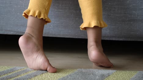 child's feet sticking out from under a bed