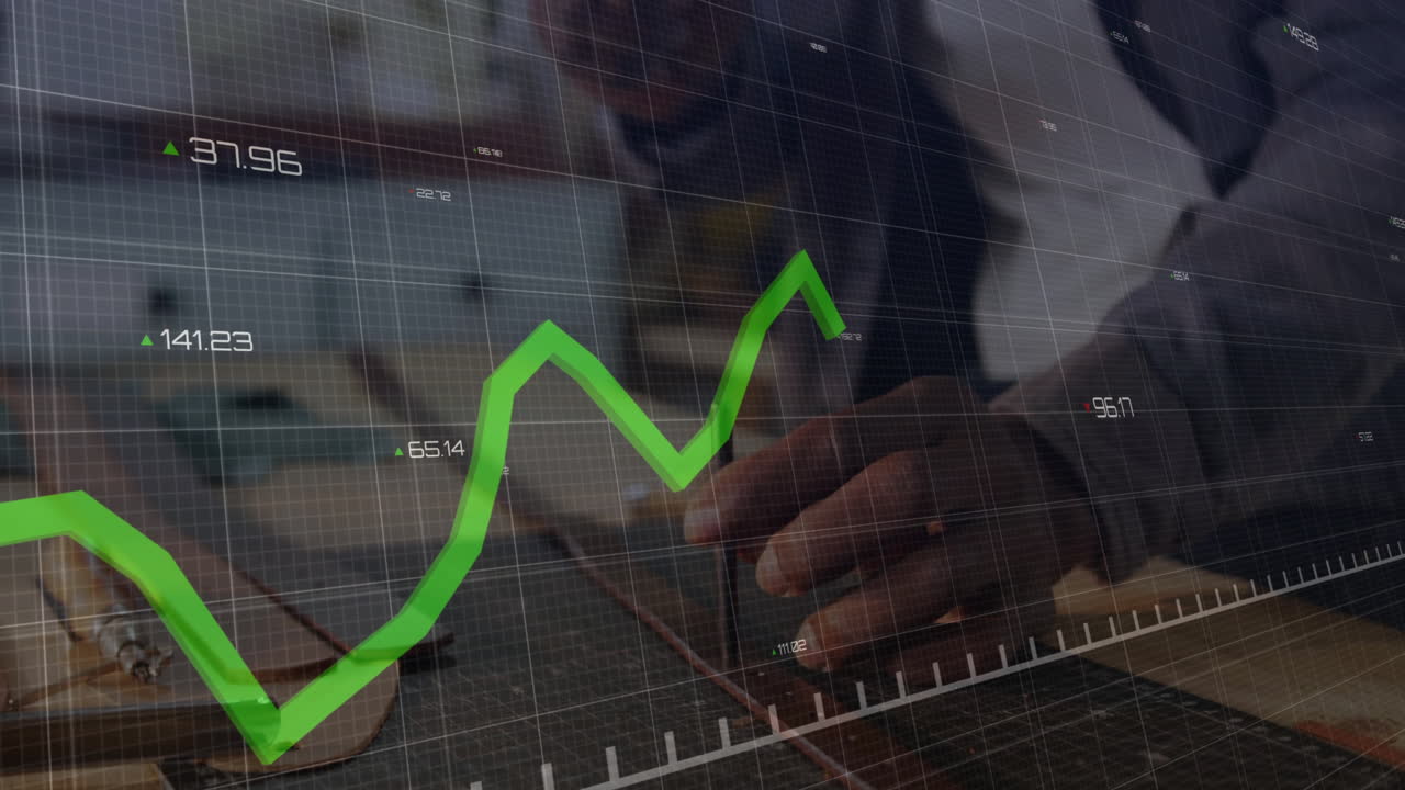 Man writing notes at wooden desk, overlaying financial chart grid with rising green line
