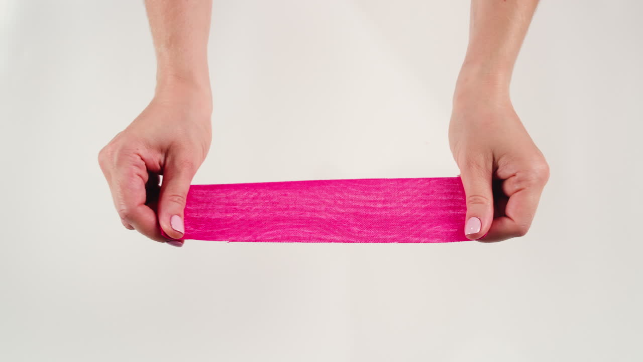 Kinesiology medical taping, doctor Physical therapist applying elastic surgical tape to patient body, treating injured knee young athlete.Post traumatic rehabilitation, sport physical therapy recovery