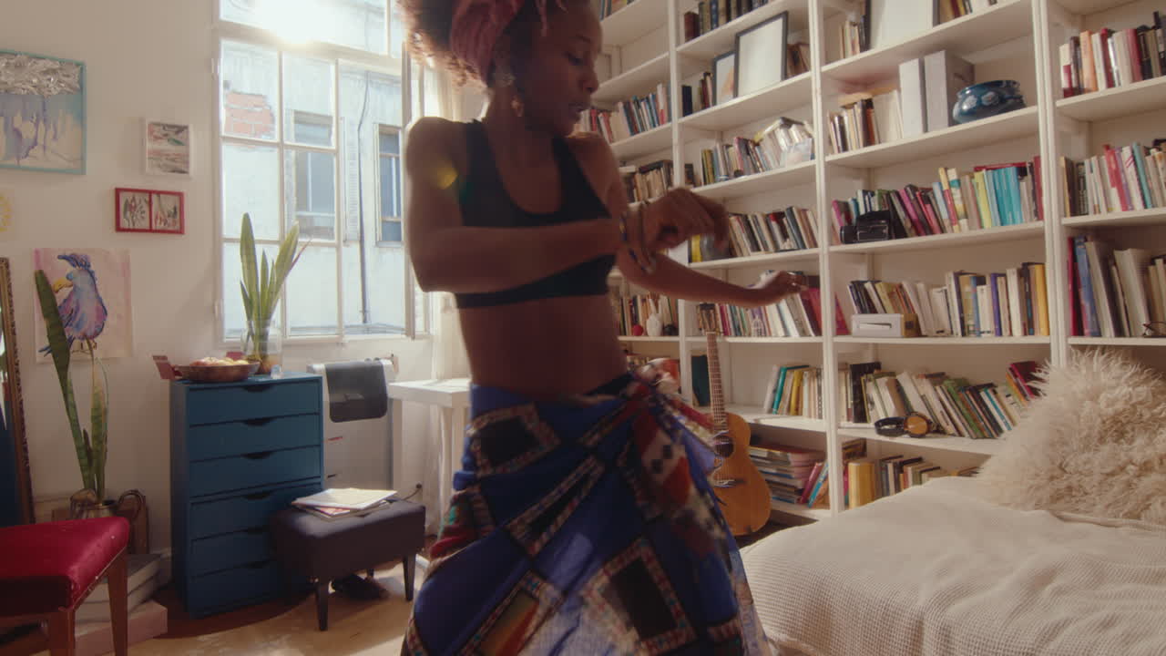 Carefree African-American Girl Dancing in Sunlit Living Room