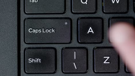 Top-View-Finger-Pushing-Caps-Lock-Button-Keyboard