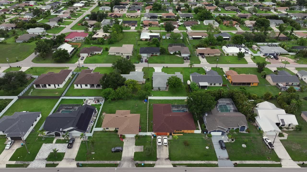 Aerial View of a Sprawling Residential Neighborhood with Houses and Green Lawns