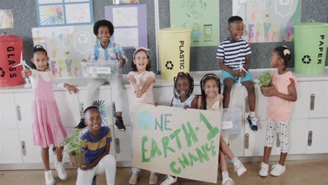 portrait of happy diverse schoolchildren with ecology models and texts at elementary school