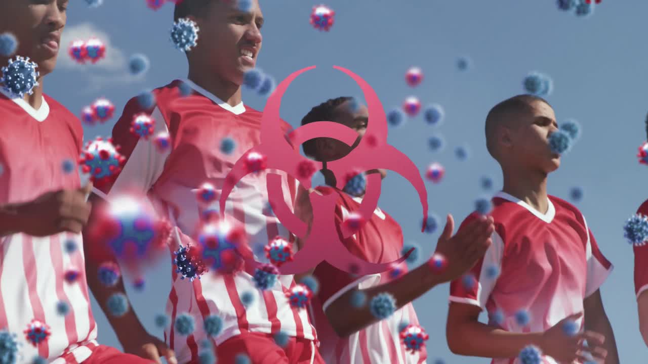 animación de células de virus sobre diversos jugadores de fútbol masculino que hacen ejercicio