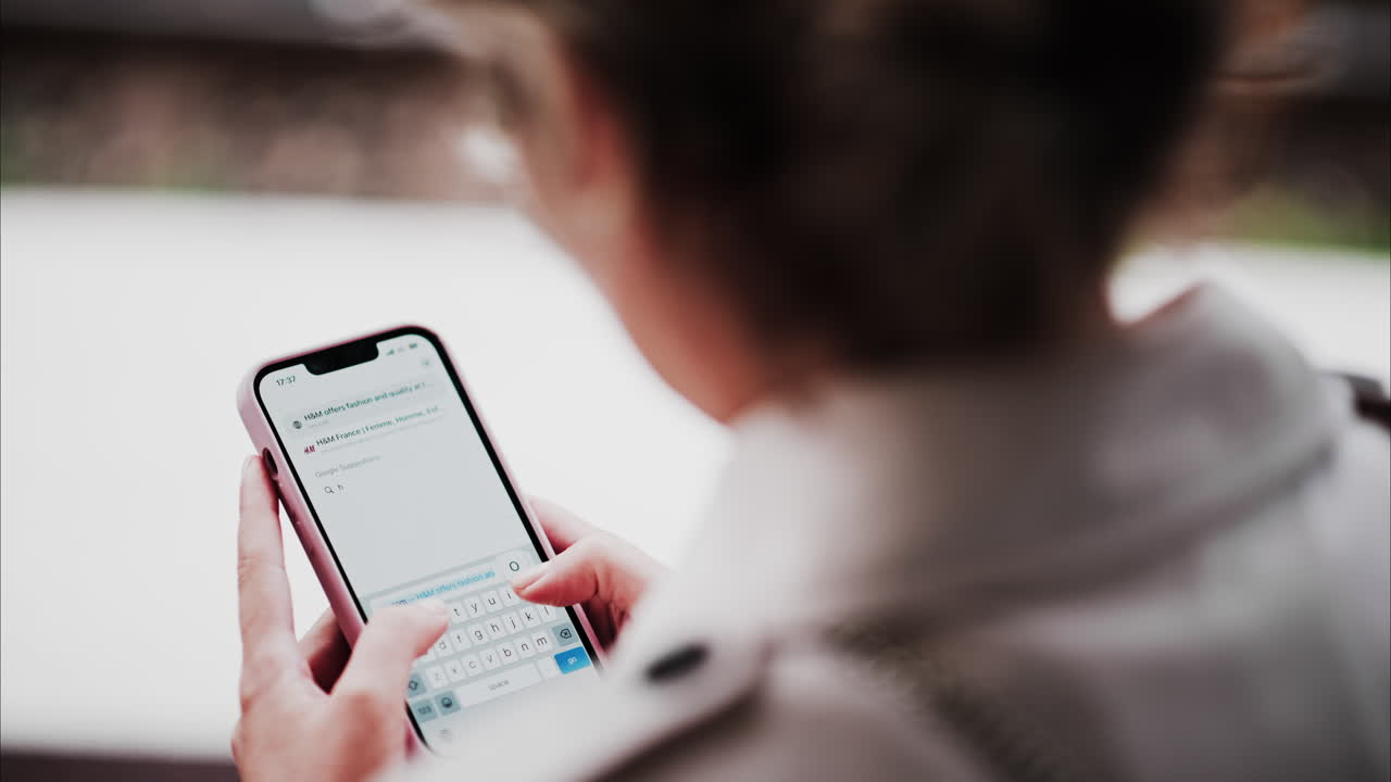 Brunette woman typing on her phone on a search engine