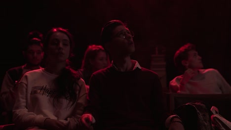 audience watching a performance in a dimly lit room