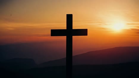 cross on mountaintop at sunset/sunrise