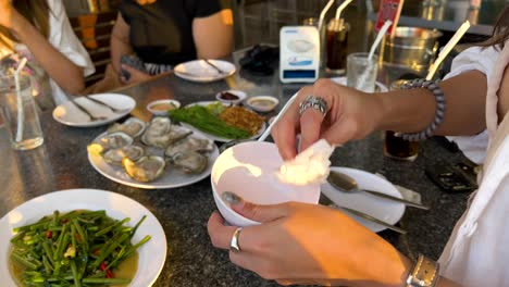 wiping a bowl at a dining table