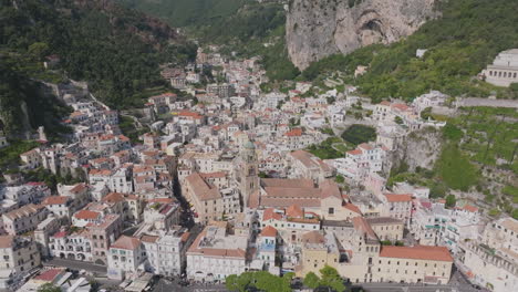 aerial fly out from the inner town of amalfi, focusing on the church tower